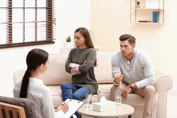 Professional psychologist working with couple in office - Fotó, kép