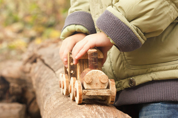 Little child playing a children's toy train in the park - Foto, Imagem