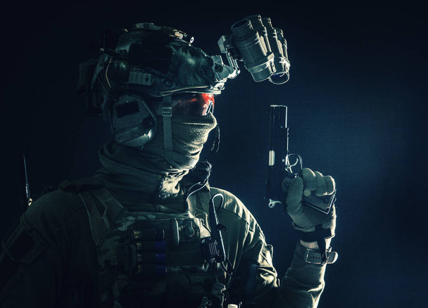 Karanlıkta hizmet tabancasıyla silahlanmış bir savaşçı - Fotoğraf, Görsel