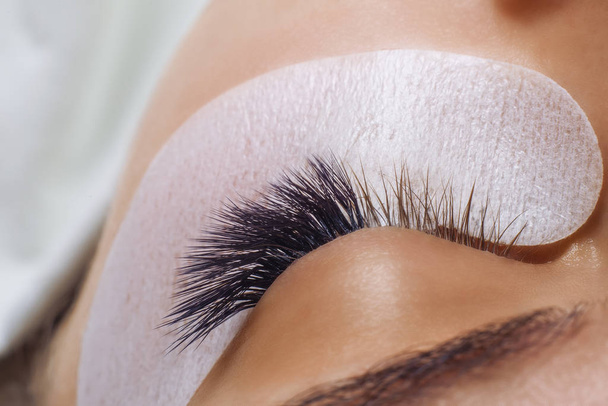 Eyelash Extension Procedure. Woman Eye with Long Blue Eyelashes. Ombre effect. Close up, selective focus. - Fotografie, Obrázek