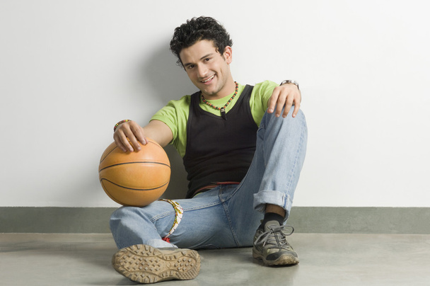 Man sitting with a ball - Foto, immagini
