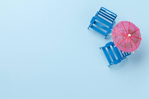 Travel concept with beach chairs and parasol. Top view flat lay with copy space - Fotoğraf, Görsel