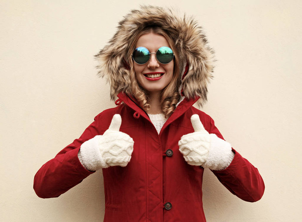 Portrait happy smiling young woman showing thumbs up wearing red - Zdjęcie, obraz