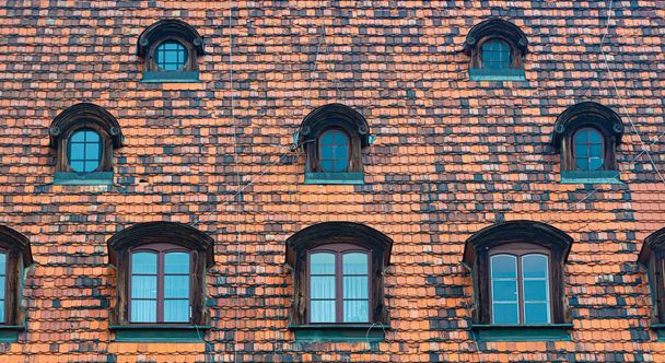 Tiled house roof with window in Wroclaw, Poland - Fotoğraf, Görsel