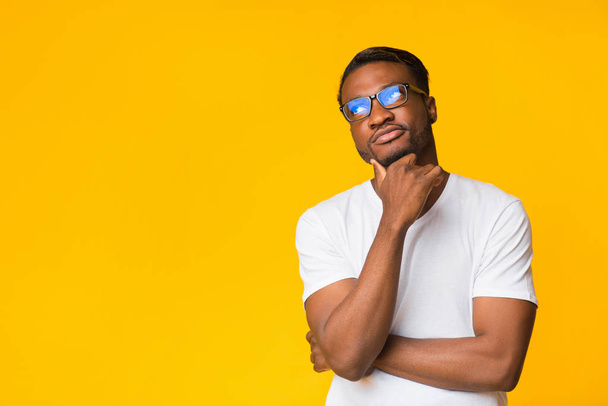 Pensive Black Guy Thinking Standing On Yellow Background, Studio Shot - Photo, Image