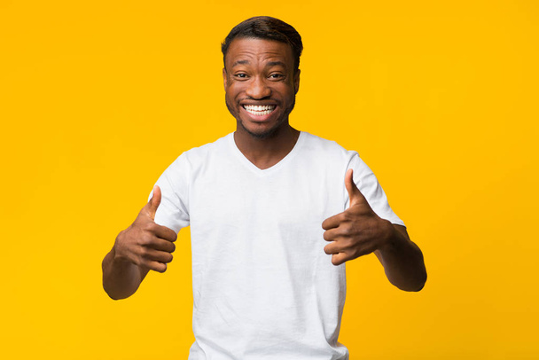 Millennial Guy Gesturing Thumbs Up With Both Hands In Studio - Фото, изображение