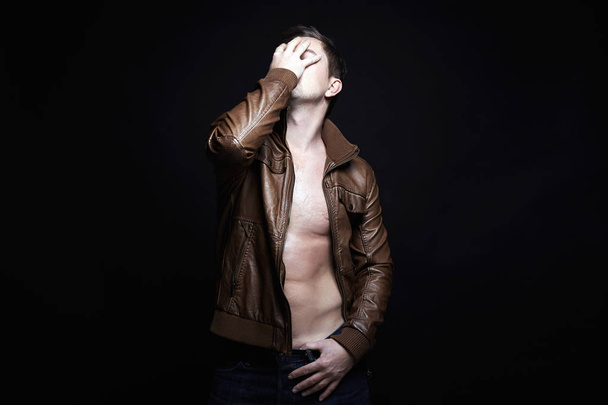 young Man in leather coat. stylish sexy Handsome Boy - 写真・画像