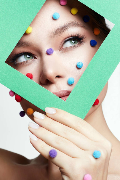 Beauty portrait of  girl with colorful balls on her face - Photo, Image