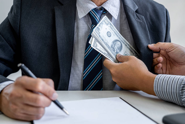 Bribery and corruption concept, bribe in the form of dollar bill - Foto, Bild