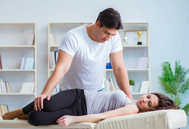 Young doctor chiropractor massaging female patient woman - Photo, Image