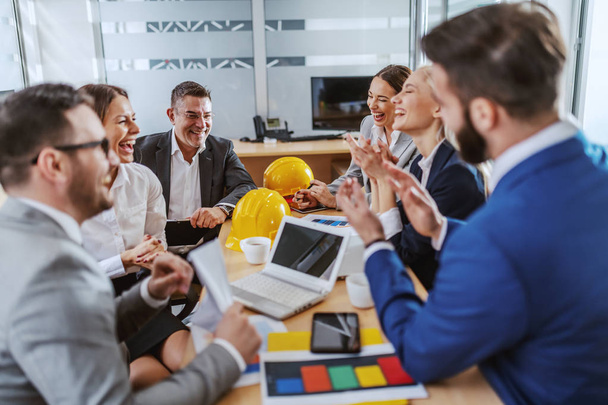 Group of cheerful business people sitting at boardroom,clapping and they are happy about success on new project. - Fotoğraf, Görsel