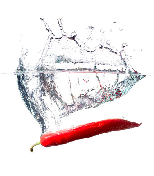Red hot paprika in water - Foto, imagen