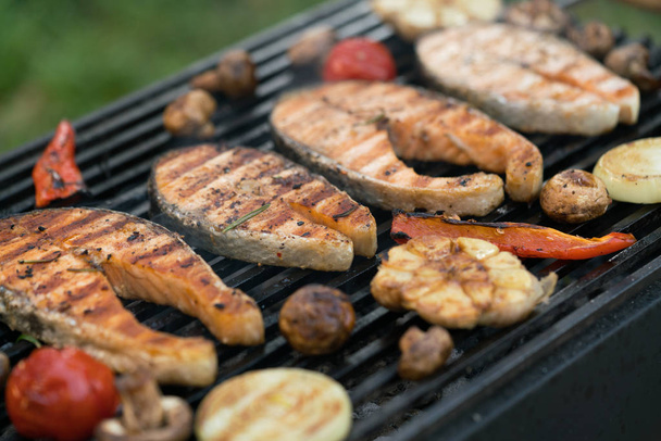 grilled salmon steaks with vegetables on the grill - Photo, Image