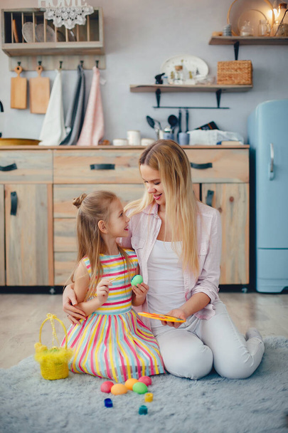 Mother with little daughter in a kitchen - Φωτογραφία, εικόνα