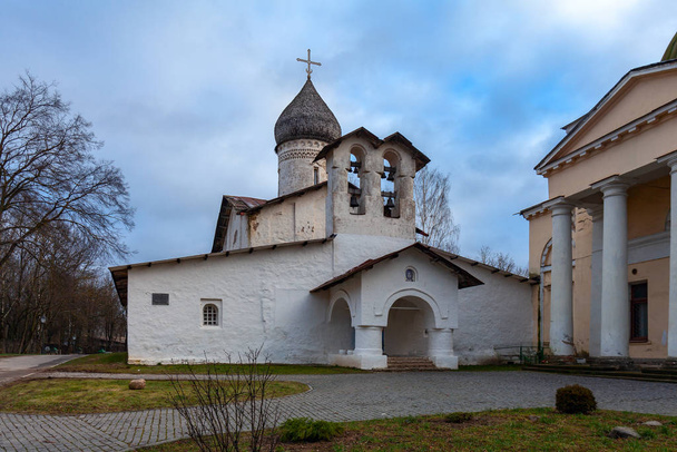 Ancient white-stone Orthodox church with a wooden tiled dome and a double bell tower - Fotografie, Obrázek