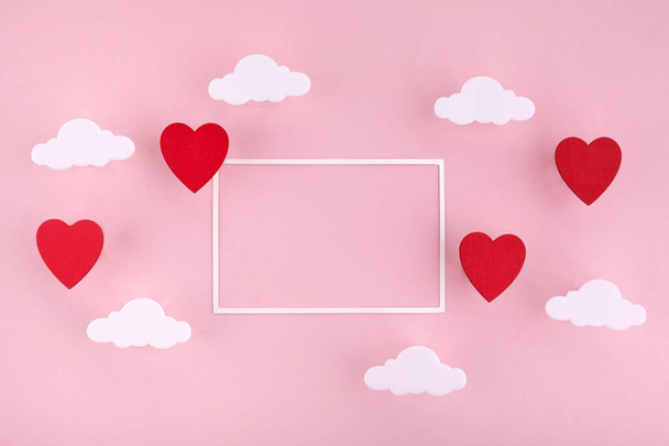 Valentines day background. Red hearts and clouds on soft pink background feel like fluffy in the air with white frame - Fotografie, Obrázek