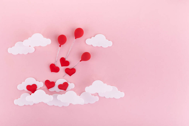 Valentines day background. Red hearts, baloons and clouds on soft pink background feel like fluffy in the air - Photo, Image