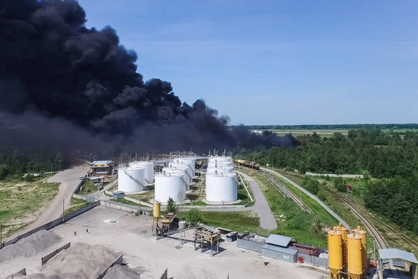 Oil storage fire. The tank farm is burning, black smoke is combu - Photo, Image