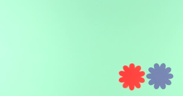 Animated stop motion background  frame of blooming paper flowers on a colored background. - Footage, Video