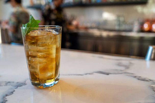 Mai tai mixed drink with mint leaf on bar counter at restaurant - Foto, imagen