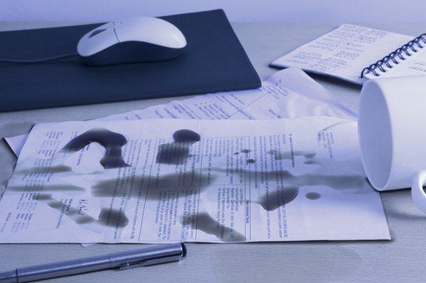 Spilt coffee over documents on a desk - Foto, imagen