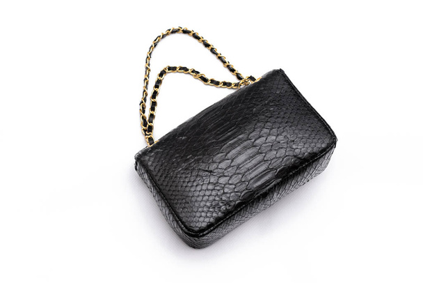 Luxury black snakeskin python leather handbag isolated on a white background. - Photo, Image