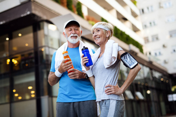 Healthy senior couple jogging in the city at early morning - Foto, Imagen