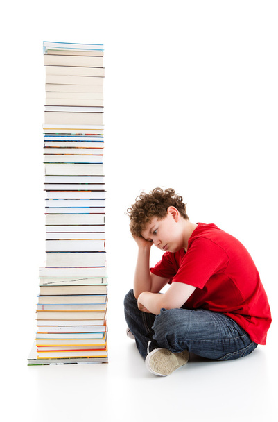 Student near the pile of books - 写真・画像