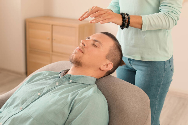 Reiki master working with patient - Photo, image