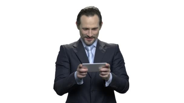 Concentrated mature business man plays game on smartphone. - Footage, Video