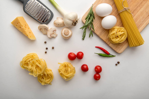 Ingredients for pasta cooking on white background - Фото, изображение