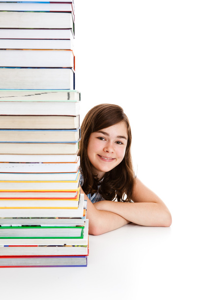 Girl behind pile of books - Foto, afbeelding