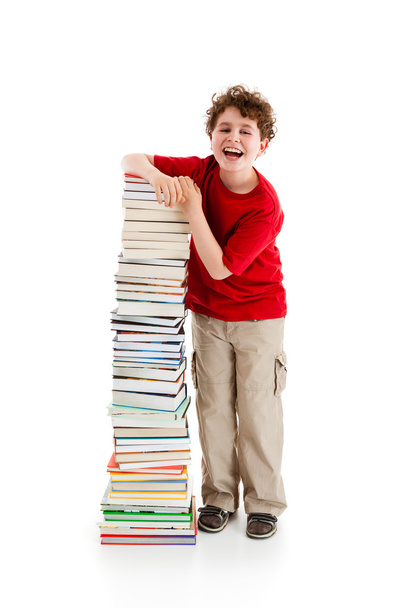 Student standing close to pile of books - Foto, afbeelding