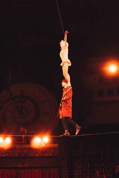 КИЕВ, УКРАИНА - 1 НОЯБРЯ 2019 г.: Низкоугольный вид воздушных гимнастов, балансирующих на веревке в цирке
  - Фото, изображение