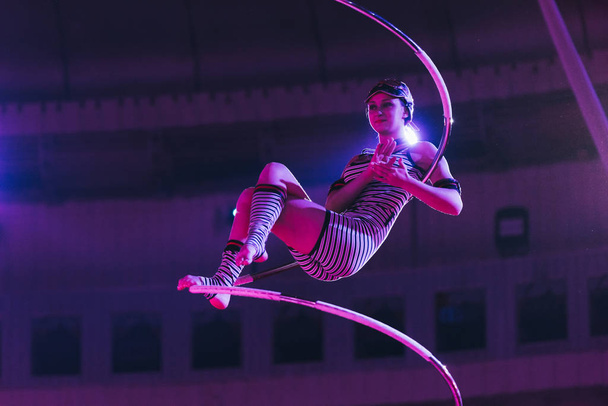 KYIV, UKRAINE - NOVEMBER 1, 2019: Air gymnast applauding while performing with equipment in circus - Valokuva, kuva