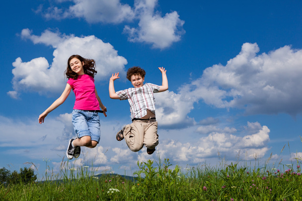 Girl and boy jumping - Фото, зображення
