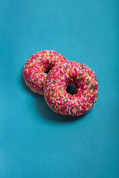 A cup of americano with two pink donuts on a blue background - Photo, image