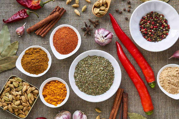 Various spices and seasonings on a fabric background                                - Photo, image