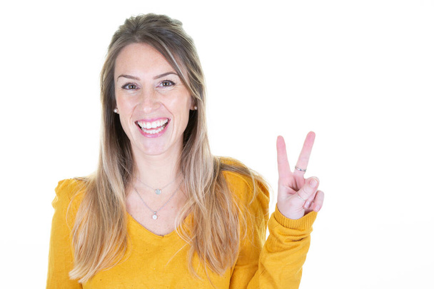 Happy young blonde woman showing v victory peace sign - Zdjęcie, obraz