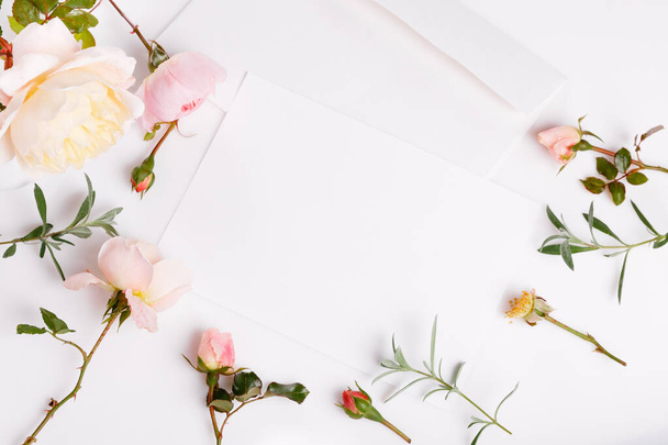 Letter, white envelope on white background with pink english rose. Invitation cards or love letter. - 写真・画像