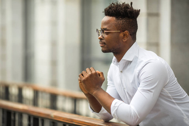 handsome young african man in a white shirt - 写真・画像