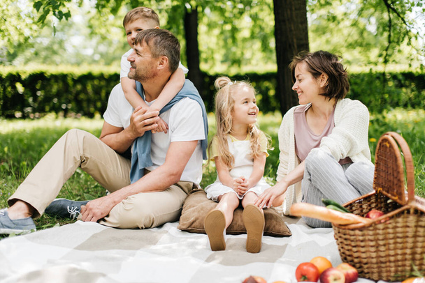 Portrait of a happy family at the picnic. - Фото, зображення