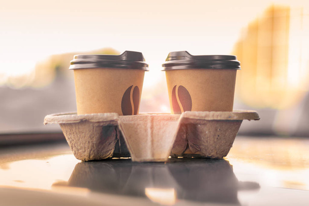 kaksi kahvipaperilasia katsovat toisiaan auringonpaisteessa
 - Valokuva, kuva