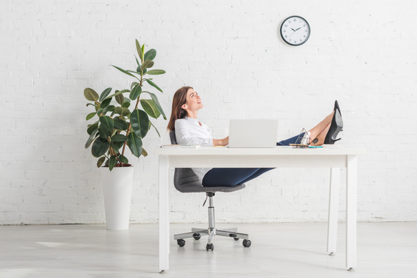 dreamy businesswoman chilling near laptop in office  - Photo, Image