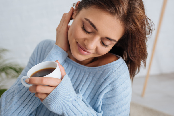 happy girl with closed eyes holding cup of coffee  - Photo, image