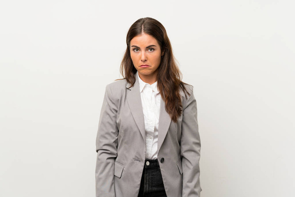 Young business woman over isolated white background sad - Valokuva, kuva