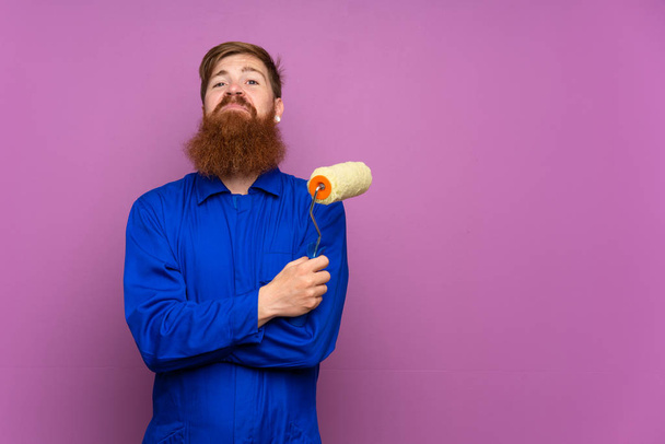 Painter man with long beard over isolated purple background - Valokuva, kuva