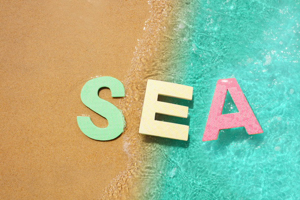 Sea sign floating in water near beach sand edge - Φωτογραφία, εικόνα