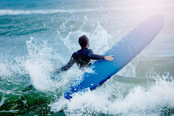 Man concur sea waves hold surf board water splash - Photo, Image