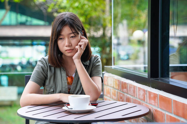woman sitting in a cafe terrace - 写真・画像